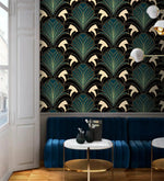 Enchanted Foliage teal fan-leaf wallpaper in lounge with navy velvet sofa, marble side tables, gold sconces