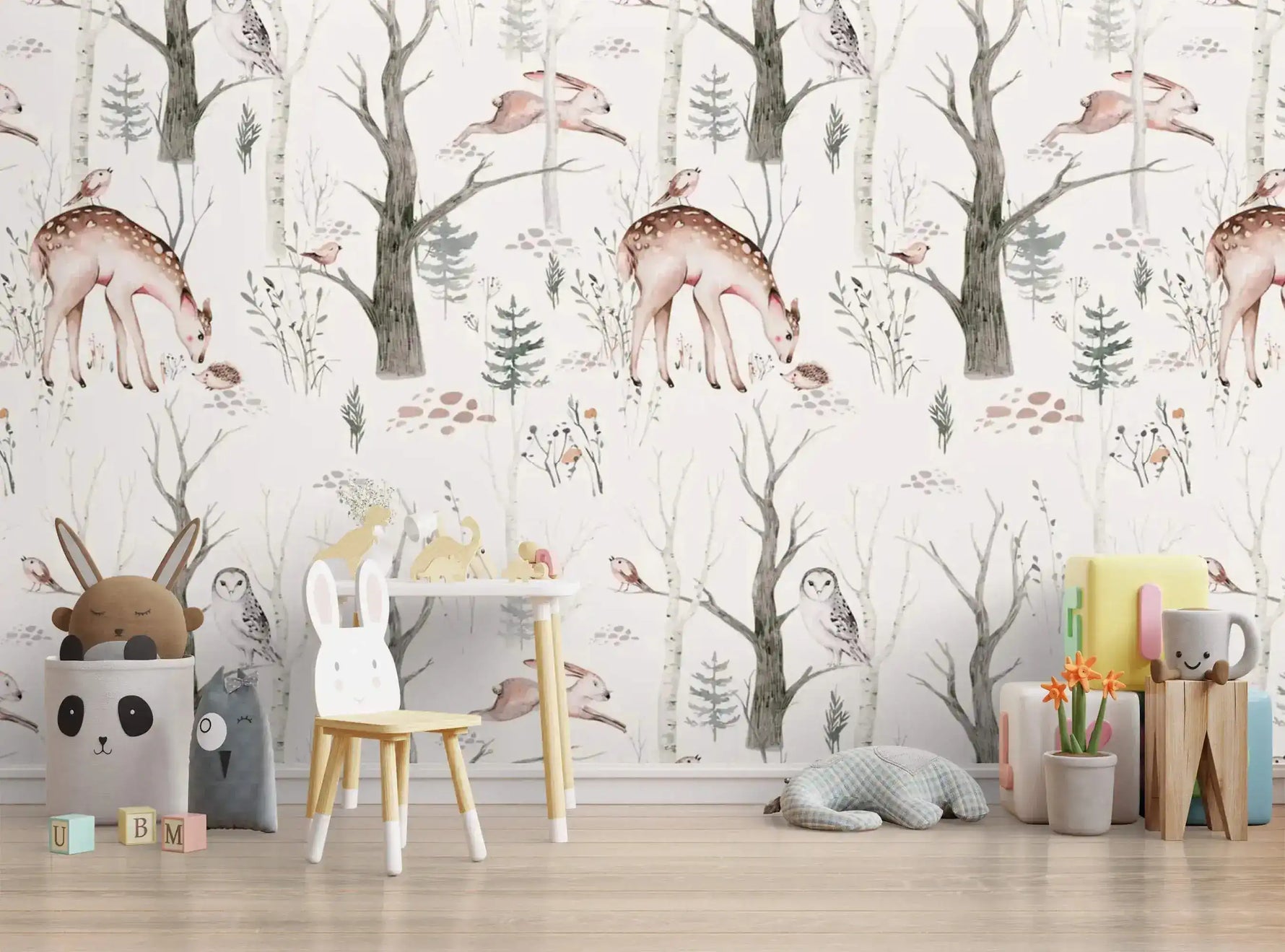 Enchanted Forest Friends mural of deer and owls styled with a child's bunny chair and toys