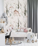Enchanted Forest Friends wallpaper with deer and owls behind a white daybed and toy pram