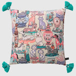 Luxurious throw pillow cover featuring a whimsical design with various animals, vases, and decorative elements, accented with turquoise tassels.