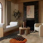 Stylish living room featuring an Energy Pulse tufted wool area rug with abstract design in vibrant colors. The rug complements the modern decor with a cozy armchair, minimalist wooden table, and elegant wall art, perfect for area rugs for living room.