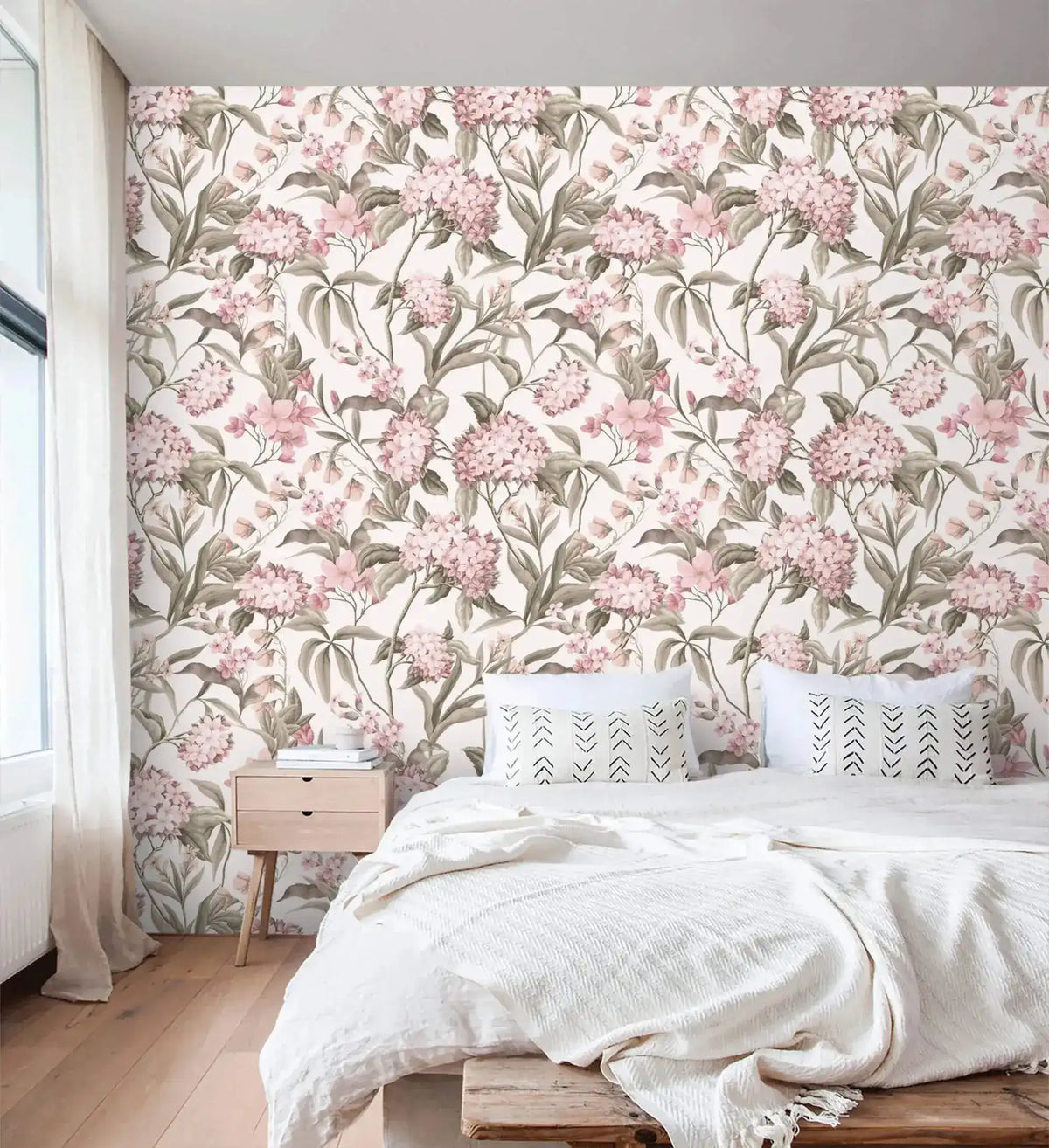 English Garden Wallpaper of pink blooms and green foliage behind a low platform bed with oak nightstand.