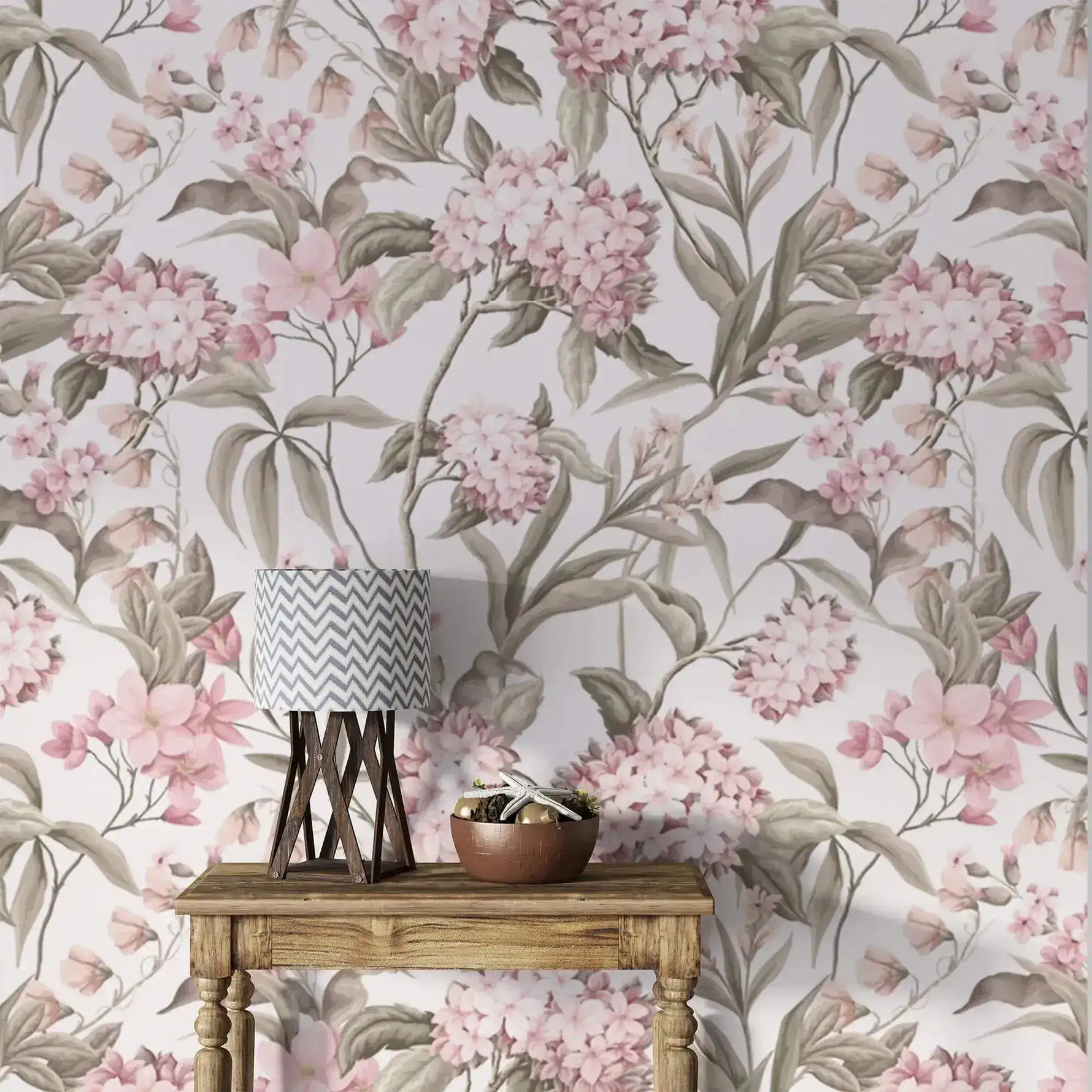 English Garden Wallpaper of soft pink hydrangeas and sage leaves on cream behind a wood console with a chevron lamp.
