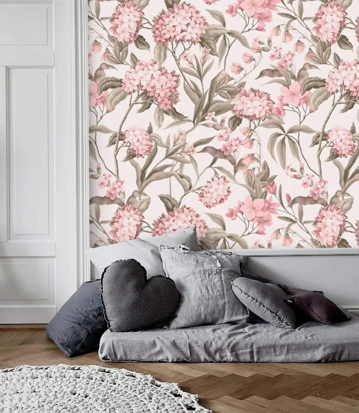 English Garden Wallpaper — pink hydrangeas and olive foliage on cream above a gray daybed and herringbone floor.