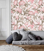 English Garden Wallpaper — pink hydrangeas and olive foliage on cream above a gray daybed and herringbone floor.