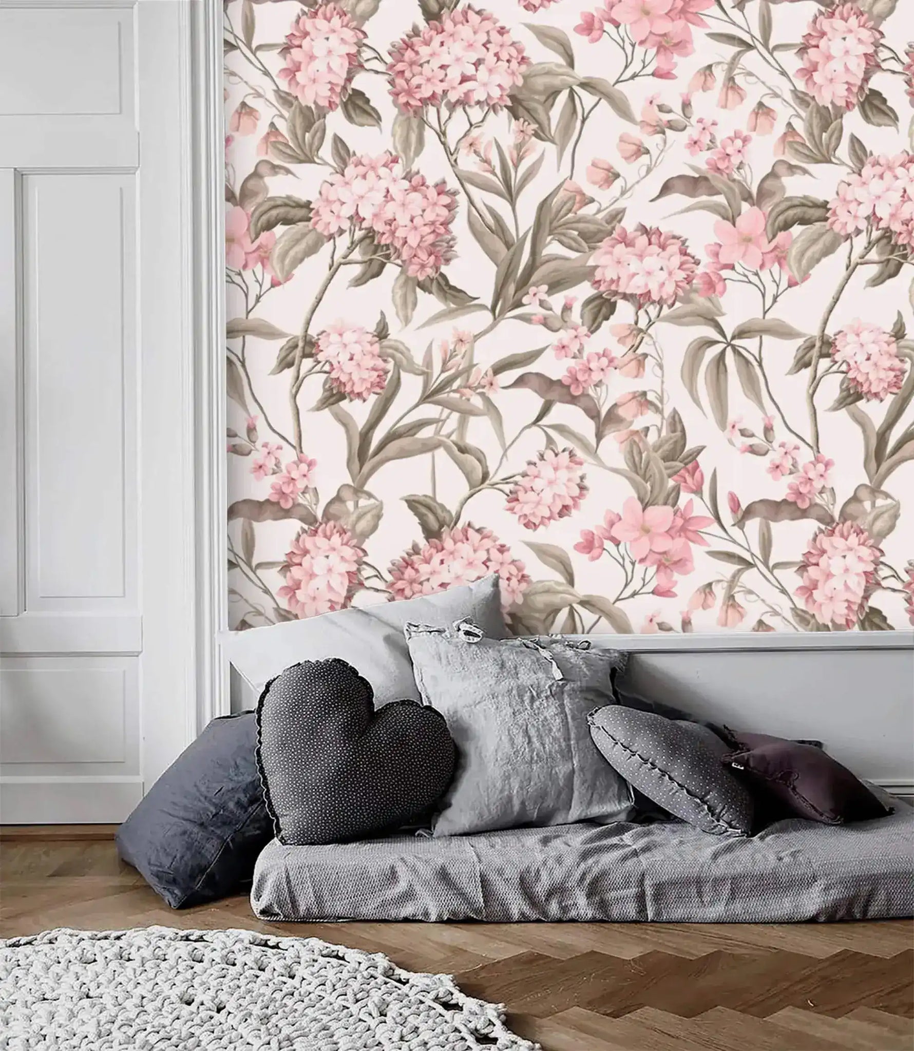 English Garden Wallpaper — pink hydrangeas and olive foliage on cream above a gray daybed and herringbone floor.