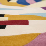 Close-up of a colorful geometric-patterned rug with various colors.
