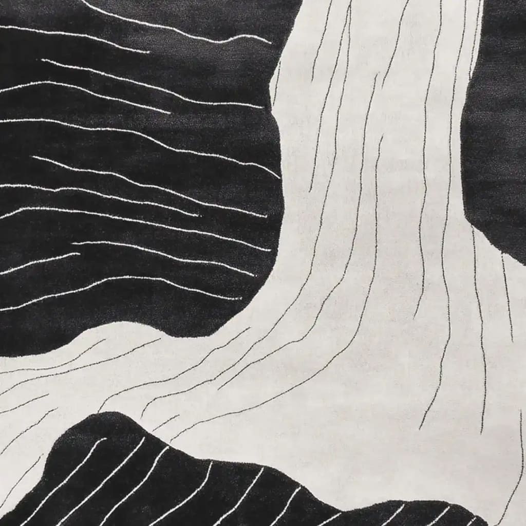 A contemporary area rug featuring an abstract black and white design resembling erosion stream veins. This hand-tufted wool rug is perfect for adding a modern touch to living room spaces. Ideal for those seeking stylish and unique living room area rugs.