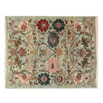 A beautifully designed area rug featuring intricate floral patterns in a harmonious blend of pastel colors. This knotted wool rug exudes elegance with its detailed craftsmanship, making it a perfect addition to any living space for a touch of timeless style.