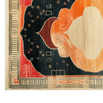Vibrant hand tufted wool rug featuring an abstract design with bold colors like orange, red, and black. The intricate patterns and geometric shapes create a striking visual appeal, perfect for adding a touch of elegance to any room. The rug's corner detail highlights the craftsmanship and texture of the area rug.