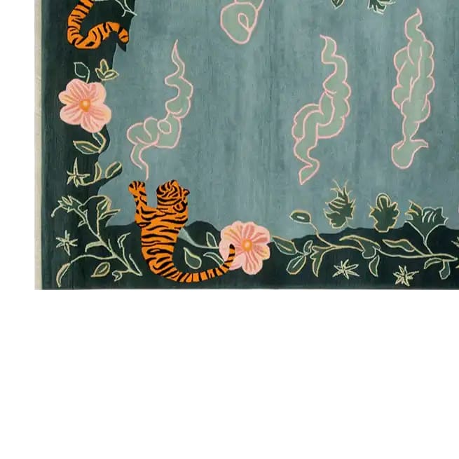 A beautifully designed area rug featuring an abstract tiger motif surrounded by delicate pink flowers and swirling patterns on a soft blue background. This hand-tufted wool rug adds a touch of whimsical elegance to any room.