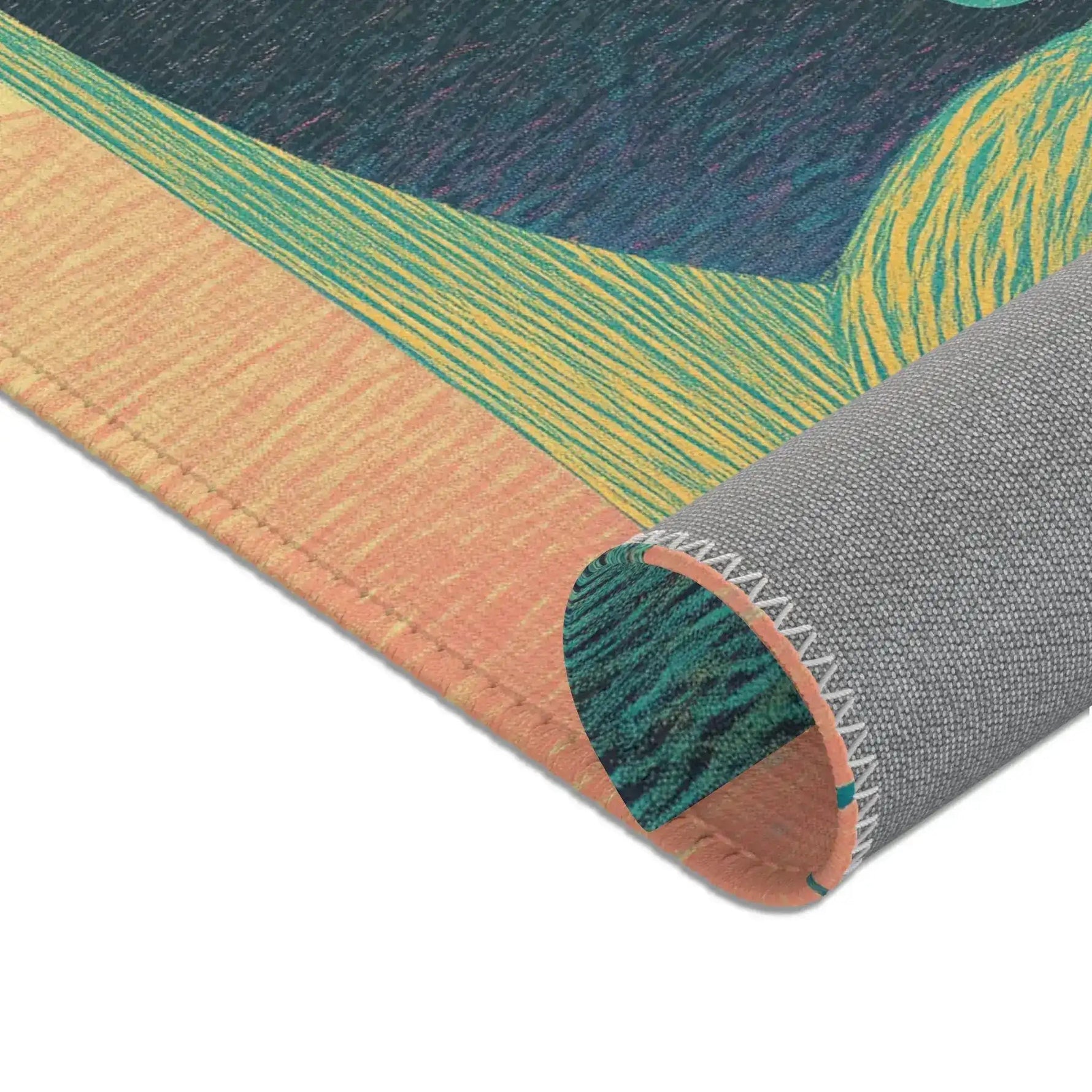 Corner of Ethereal Guardian Accent Rug curled showing peach and teal-green striped guardian print with gray non-slip backing and serged stitched edge