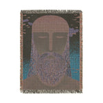Portrait back view of ethereal guardian woven blanket in dark charcoal ground, lavender-blue beard, teal sides, fringed edges