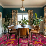 This vibrant Ethnic Harmony Tapestry Wool Hand Knotted Area Rug adds a splash of color to a formal dining room setting. The square area rug features intricate Persian-inspired designs in pink, yellow, and green hues, perfectly complementing the wooden dining table and chairs. Ideal for those seeking dining room area rugs that combine elegance with a touch of tradition.
