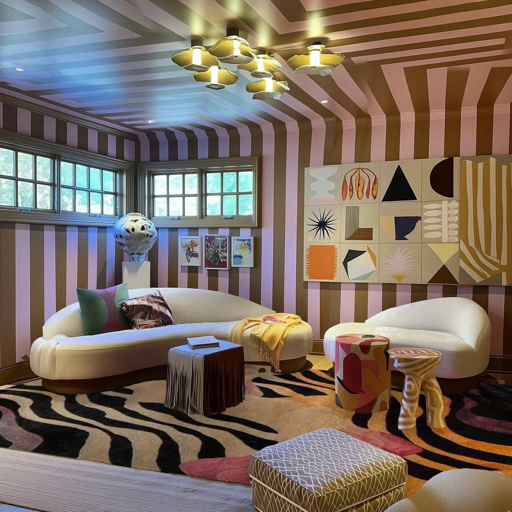 Evolving Forms viscose rug with zebra stripe pattern in cream and black, styled in eclectic room with curved sofa
