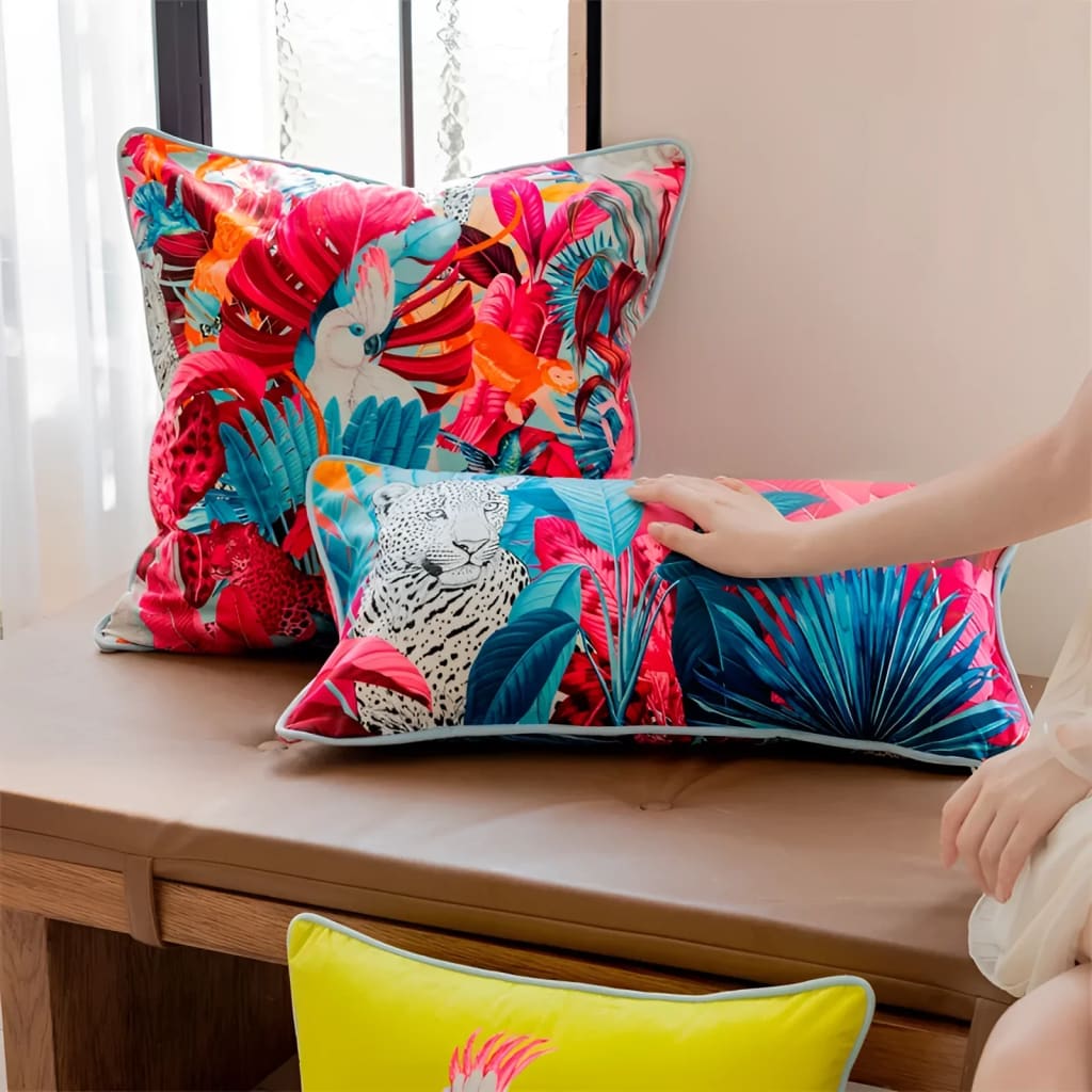 Vibrant throw pillows featuring tropical designs with colorful leaves and exotic animals, perfect for adding a touch of paradise to your home decor.