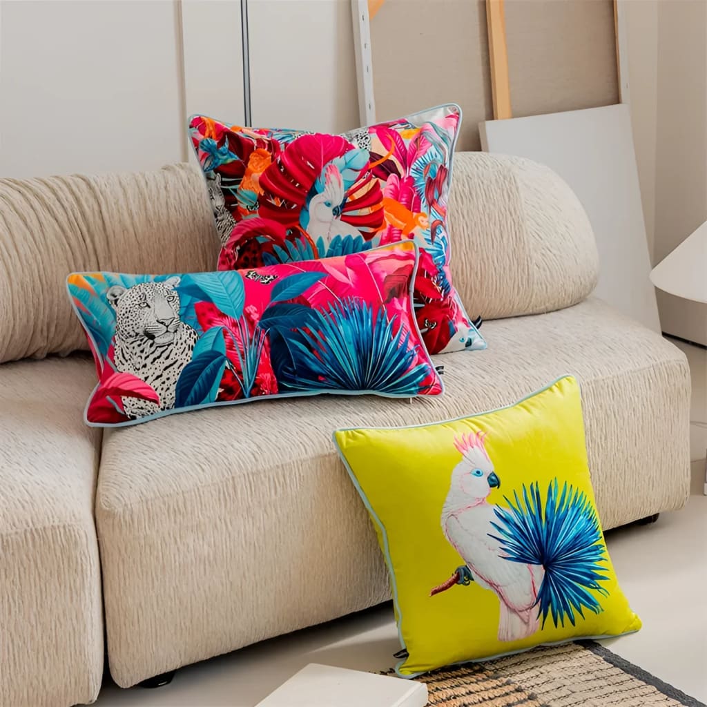 Colorful throw pillows featuring exotic designs, including vibrant parrots and tropical foliage, perfect for adding a pop of color to any living space.