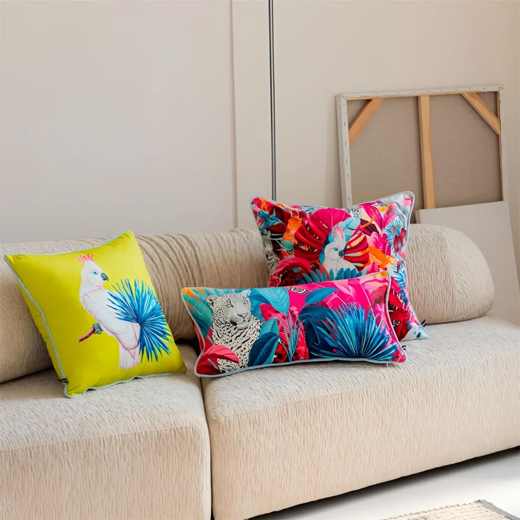 Vibrant throw pillows featuring exotic designs on a beige couch, perfect for adding a tropical touch to your home decor.