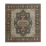 A vibrant hand-knotted area rug featuring intricate Persian-inspired patterns with rich colors, including pink, blue, and beige. The ornate design showcases a central medallion surrounded by detailed floral and geometric motifs, creating an exotic and luxurious feel.