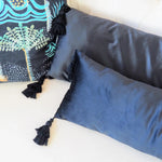 Extra skinny black throw pillow with tassels, perfect for adding a stylish touch to any decor.