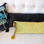 Extra skinny black throw pillow with tassels, perfect for lumbar support and decorative accents.