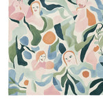 This vibrant hand-tufted area rug features abstract faces interwoven with floral patterns, creating a contemporary design. Perfect for adding a touch of artistry to your living room, this 8x10 wool rug brings life and color to large spaces.