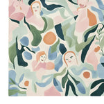 This vibrant hand-tufted area rug features abstract faces interwoven with floral patterns, creating a contemporary design. Perfect for adding a touch of artistry to your living room, this 8x10 wool rug brings life and color to large spaces.