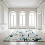 Decorative rug with floral pattern in a bright, elegant room with arched windows.