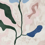 Close-up image of the Fading Petal Motion Hand Tufted Area Rug showcasing a contemporary abstract design with green, pink, and blue petal-like shapes. Perfect wool rug for enhancing any living room with a modern touch.