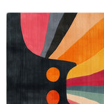 Colorful abstract area rug with a striking design featuring vibrant shades of orange, pink, and black, adding a bold artistic touch to any room.