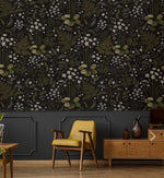 Fern blossoms monochrome wallpaper above dark wainscoting with a mustard yellow armchair and wood sideboard below