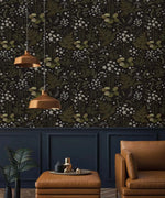 Fern blossoms monochrome wallpaper as accent wall in dark living room with copper pendants and tan leather armchair