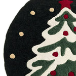 Close-up view of the Festive Evergreen Round Hand Tufted Area Rug, perfect for adding a touch of holiday cheer to your living room or office. This wool rug features a charming evergreen tree design with red accents, set against a dark background, making it an ideal choice for round rugs in cozy spaces.