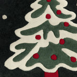 Close-up of the Festive Evergreen Round Hand Tufted Rug, featuring a vibrant holiday design with a green and white Christmas tree adorned with red accents. This wool area rug is perfect for adding a touch of festivity to your living room or office space. Ideal for those seeking unique round office rugs or area rugs for the living room.