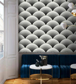 Fish scale art deco wallpaper above blue velvet banquette, black and white scalloped fan pattern