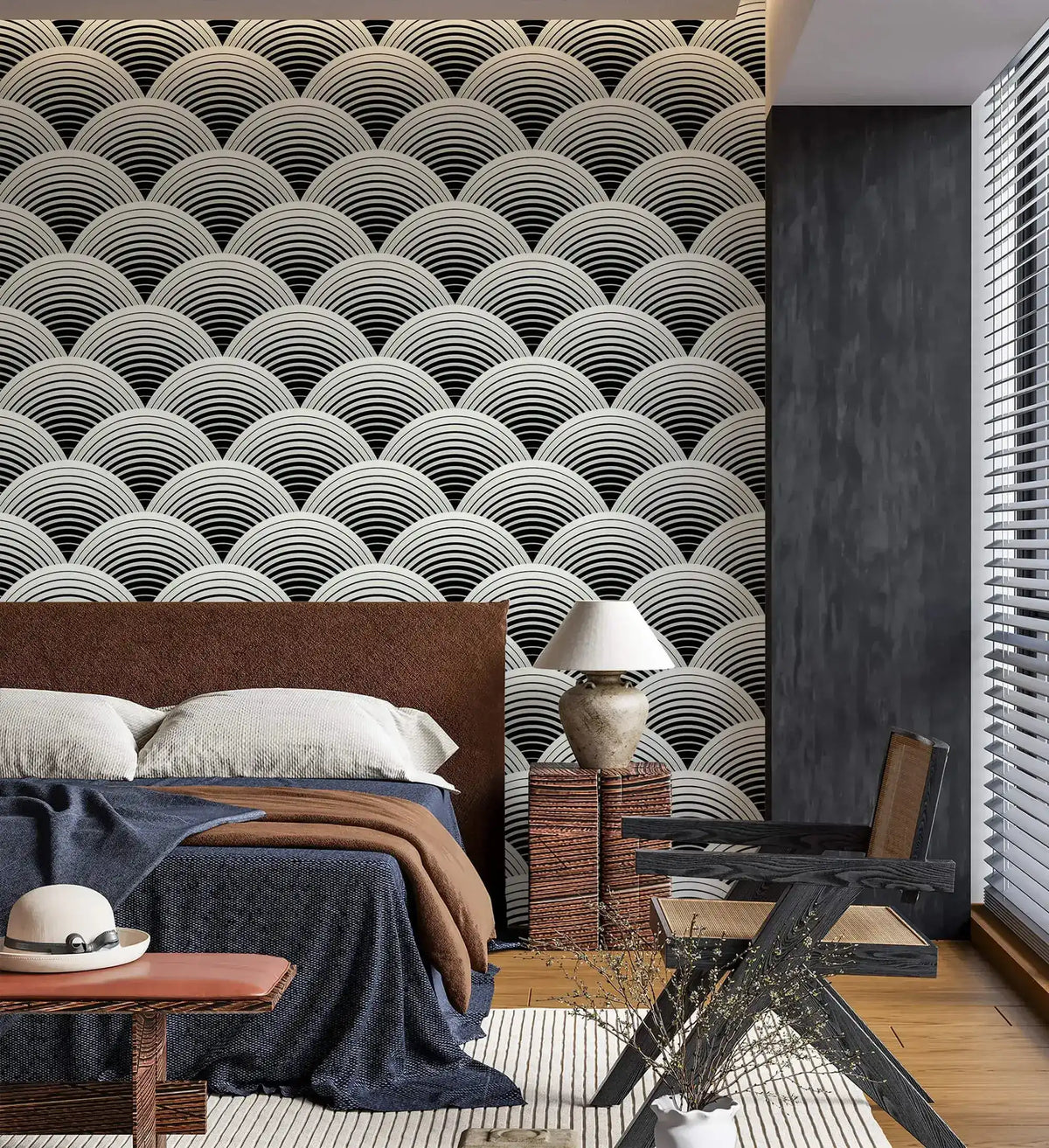 Fish scale art deco wallpaper behind a bed, black and white scalloped fans as a bedroom feature wall