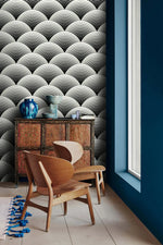 Fish scale art deco wallpaper by a window, black and white scalloped fans above a carved cabinet