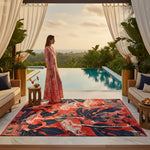 Woman in a pink dress standing by a pool with a decorative flamingo rug in the foreground.