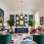 Luxurious salon lobby room with colorful decor, furniture, a contemporary hand-tufted wool rug, and artwork.