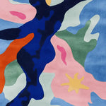 Vibrant and contemporary hand-tufted wool area rug featuring an abstract design with bold colors, perfect for a large living room. This square area rug showcases a mix of blue, pink, green, and orange hues, adding a modern touch to any space.