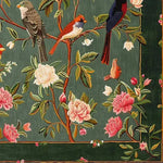 A beautifully detailed square area rug featuring a vibrant floral and fauna design with birds perched on branches against a dark green wool background. Perfect for adding elegance to living rooms or offices, this hand-tufted wool rug enhances any space with its rich colors and intricate patterns.