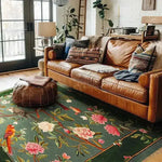 A cozy living room showcasing a beautiful Flora & Fauna Square Hand Tufted Wool Rug with vibrant floral patterns. The square area rug's intricate design adds a touch of elegance, making it perfect for both office and living room settings. The rich wool texture complements the warm tones of the leather sofa and eclectic cushions, creating an inviting ambiance.