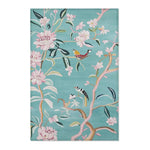 Teal floral birds accent rug showing top edge fabric texture with pink blossoms and birds on branches