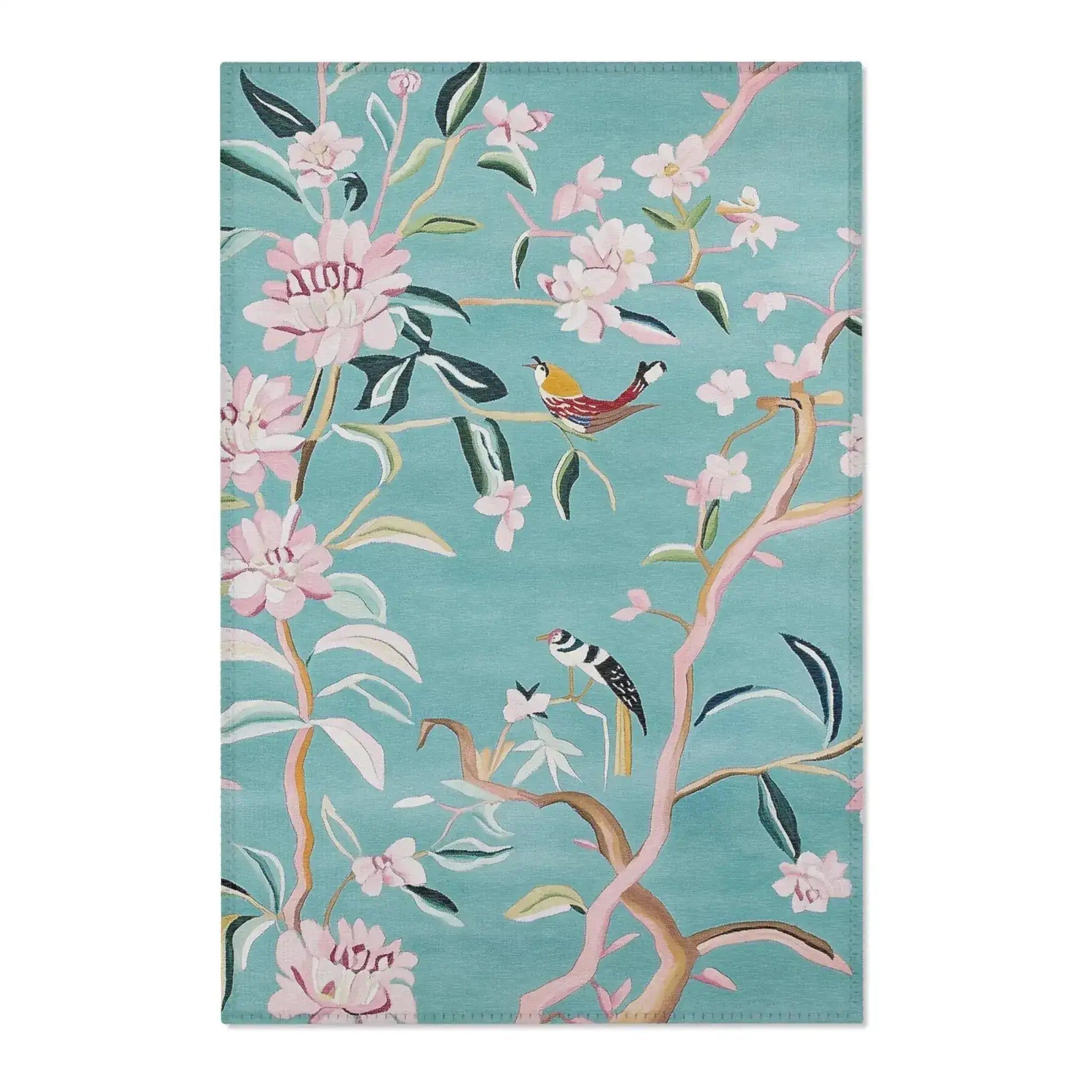 Teal floral birds accent rug showing top edge fabric texture with pink blossoms and birds on branches