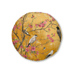 Round floor pillow with amber-gold chinoiserie print, birds perched on cherry blossom branches, pink blooms, Floral Birds and Blossoms Floor Pillow front view
