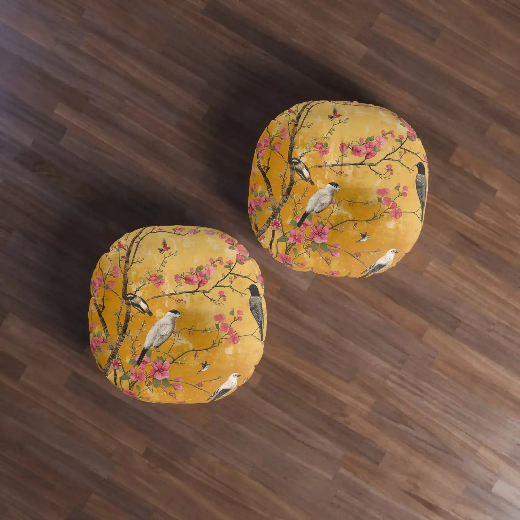 Two round floor pillows on wood floor, amber-gold chinoiserie birds-and-blossoms print, Floral Birds and Blossoms Floor Pillow pair view from above