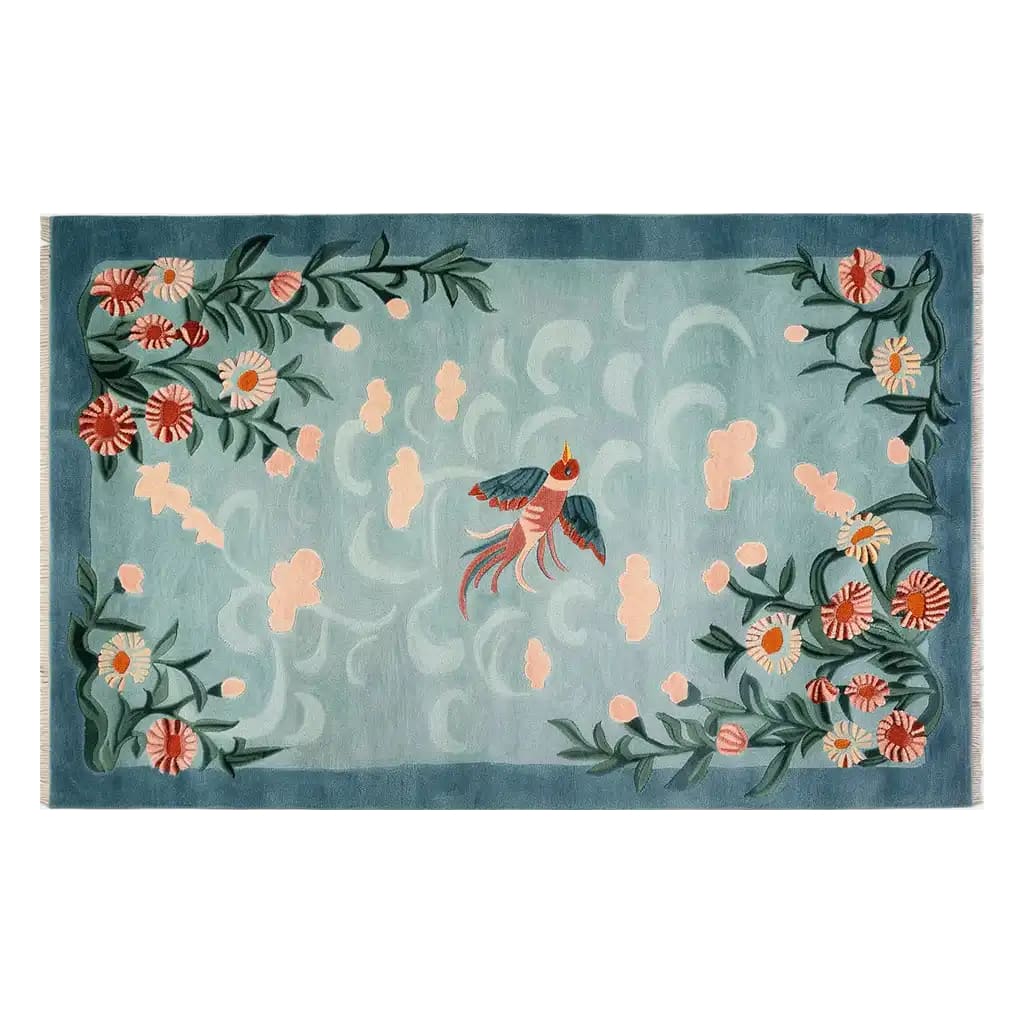 A beautifully designed area rug featuring a serene floral and bird motif on a soft blue background. This wool rug, perfect for living room area rugs, showcases intricate patterns and vibrant colors, adding a touch of elegance to any space.