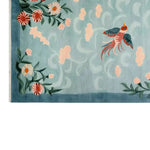 A charming Floral Breeze Knotted Wool Rug featuring an intricate design of vibrant flowers and a colorful bird against a soft blue background. This elegant area rug adds a touch of nature-inspired beauty, perfect for enhancing any living room area with its warm wool texture.
