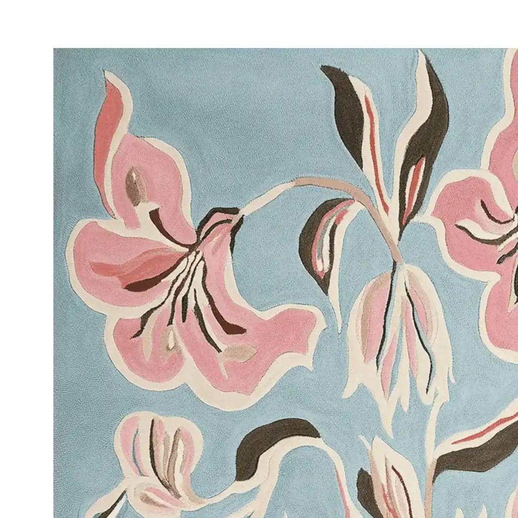 Close-up of a Floral Brush Symphony Hand Tufted Area Rug, showcasing a contemporary design with pink and black floral patterns on a soft blue background, perfect for adding a touch of elegance to any living room. Made from high-quality wool, this rug combines style and comfort, ideal for those seeking a contemporary wool rug.