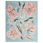 Close-up of a pink flower design on a textured rug with a blue background